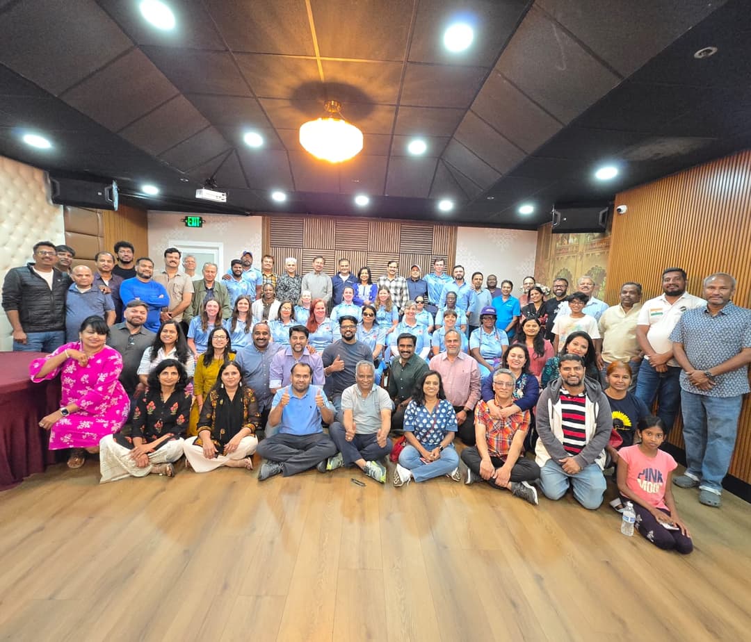 A room full of people posing for a group photo