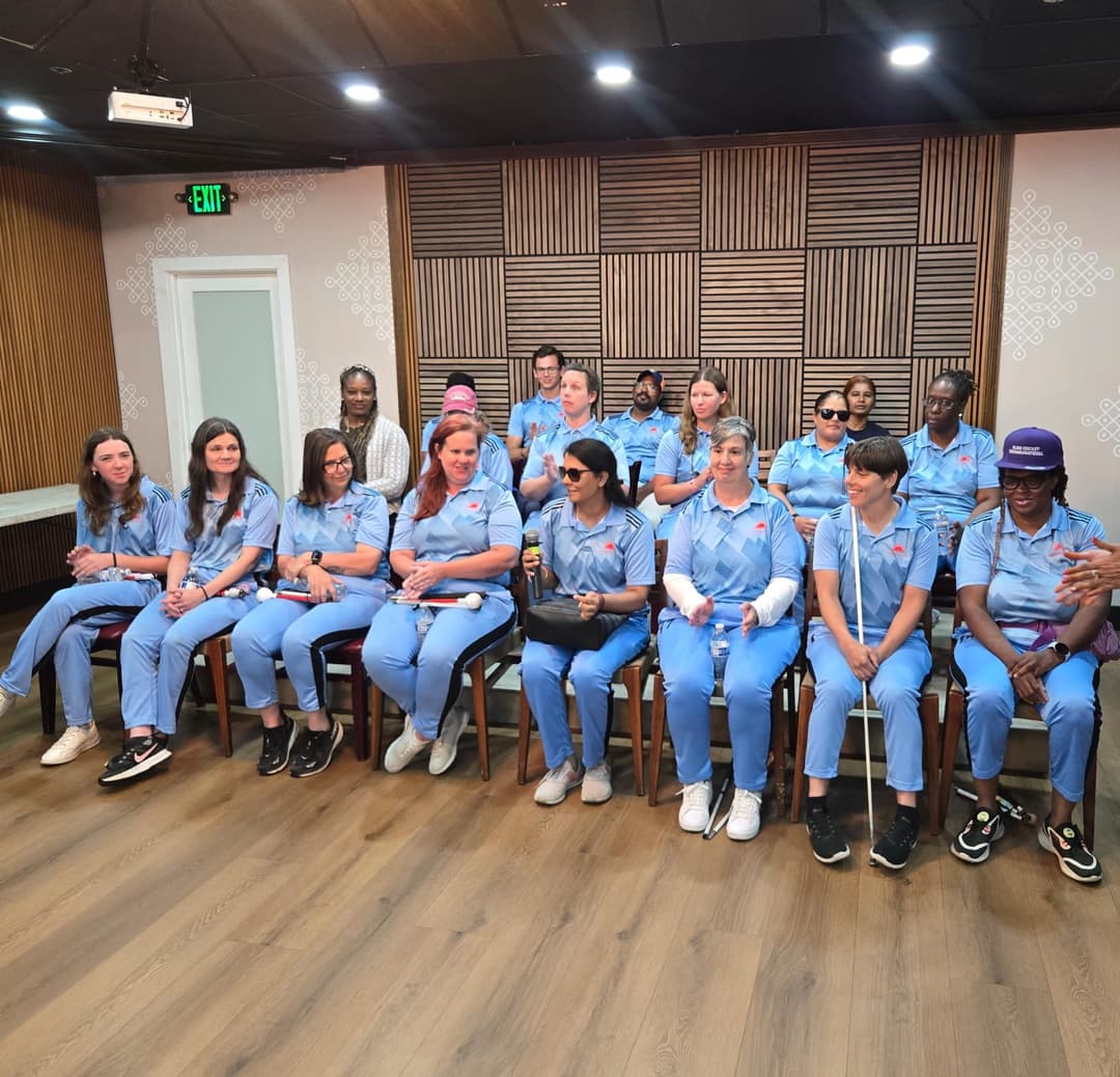 Cricket team sitting and enjoying the event.